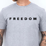 Gray t-shirt with 'FREEDOM' text worn by a person