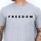 Gray t-shirt with 'FREEDOM' text worn by a person