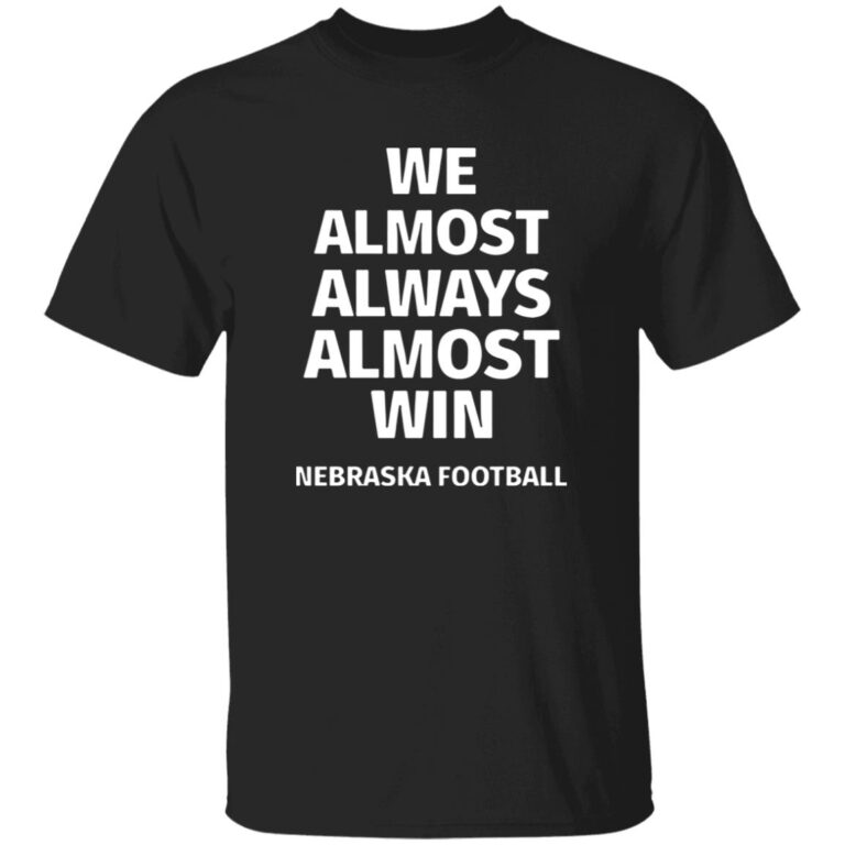 Black t-shirt with white text 'WE ALMOST ALWAYS ALMOST WIN NEBRASKA FOOTBALL' on a white background