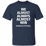 Navy blue t-shirt with white text 'WE ALMOST ALWAYS ALMOST WIN NEBRASKA FOOTBALL' on a white background