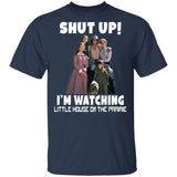 Navy blue t-shirt with 'Shut Up! I'm Watching Little House on the Prairie' text and character graphic.