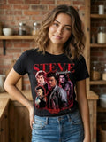 Woman wearing a black Steve Harrington Shirt with a graphic design in a kitchen setting